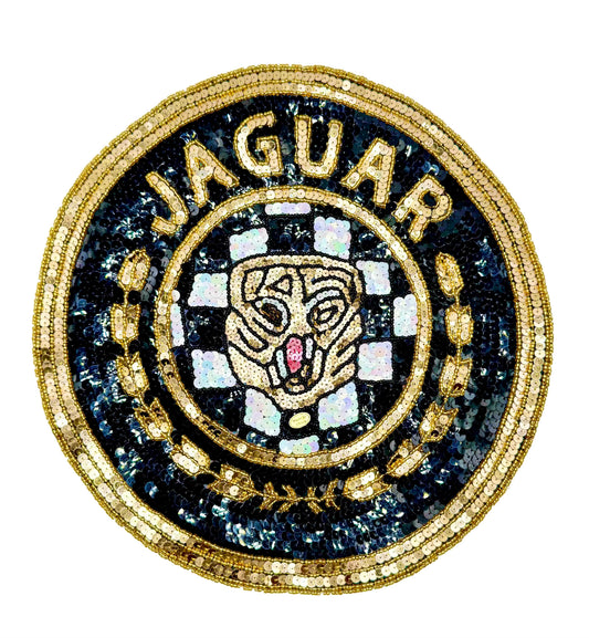 A circular sequin and bead vintage patch featuring the word 'JAGUAR' in gold around a stylized jaguar head on a black and white checkered background, with gold sequined detailing.