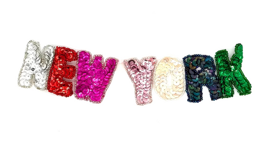 Colorful sequin and bead 'New York' text on a white background