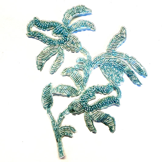 Bring a fresh floral accent to your next design with this mint beaded flower appliqué. The decorative beadwork adds texture and detail, creating a focal point for clothing, costumes, and accessories.