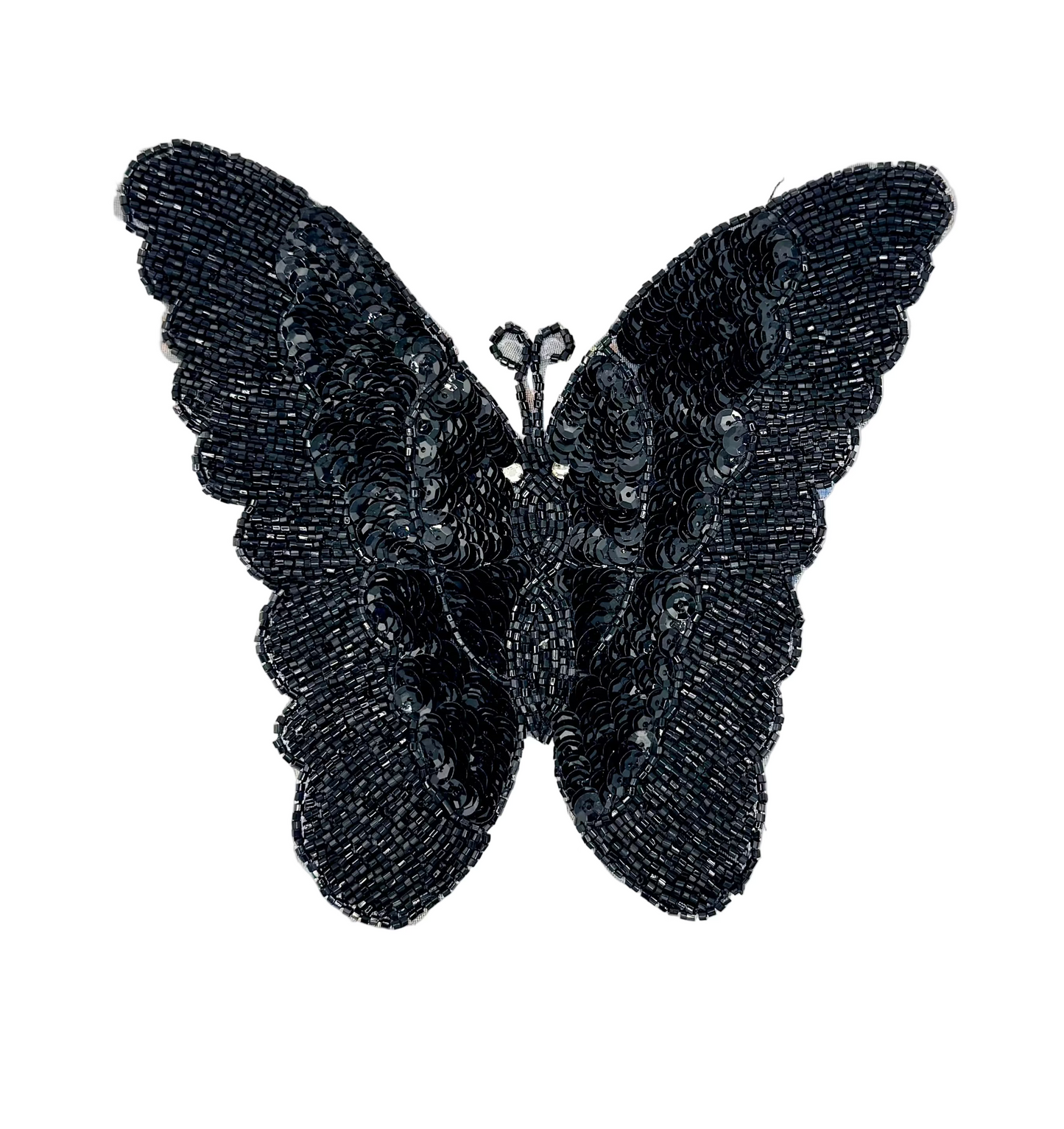 Black sequin and bead butterfly-shaped decorative item on a white background