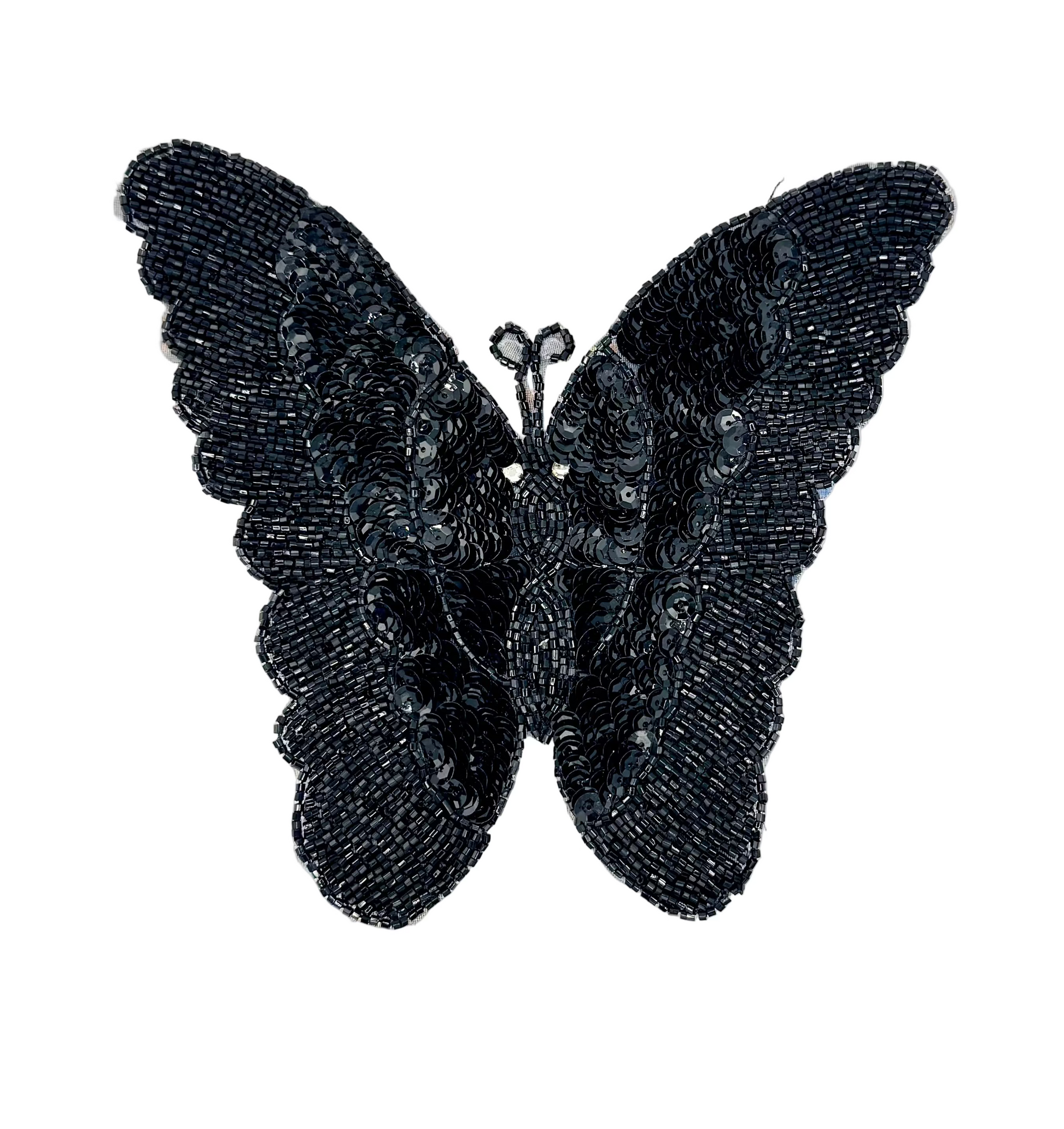 Black sequin and bead butterfly-shaped decorative item on a white background