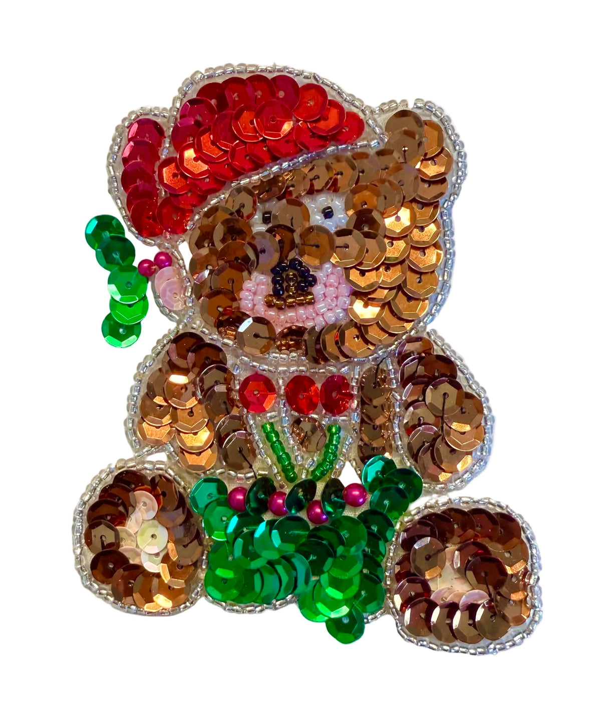 A festive teddy bear sequin decoration featuring a brown sequined bear wearing a red sequin Santa hat and holding green and red sequin holly, set against a plain white background.