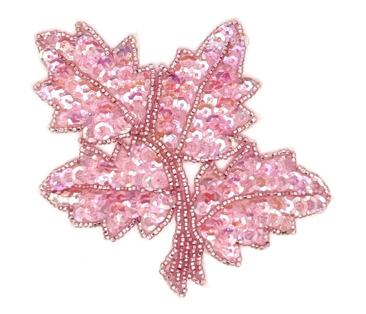 Iridescent pink leaf-shaped decorative item on a white background