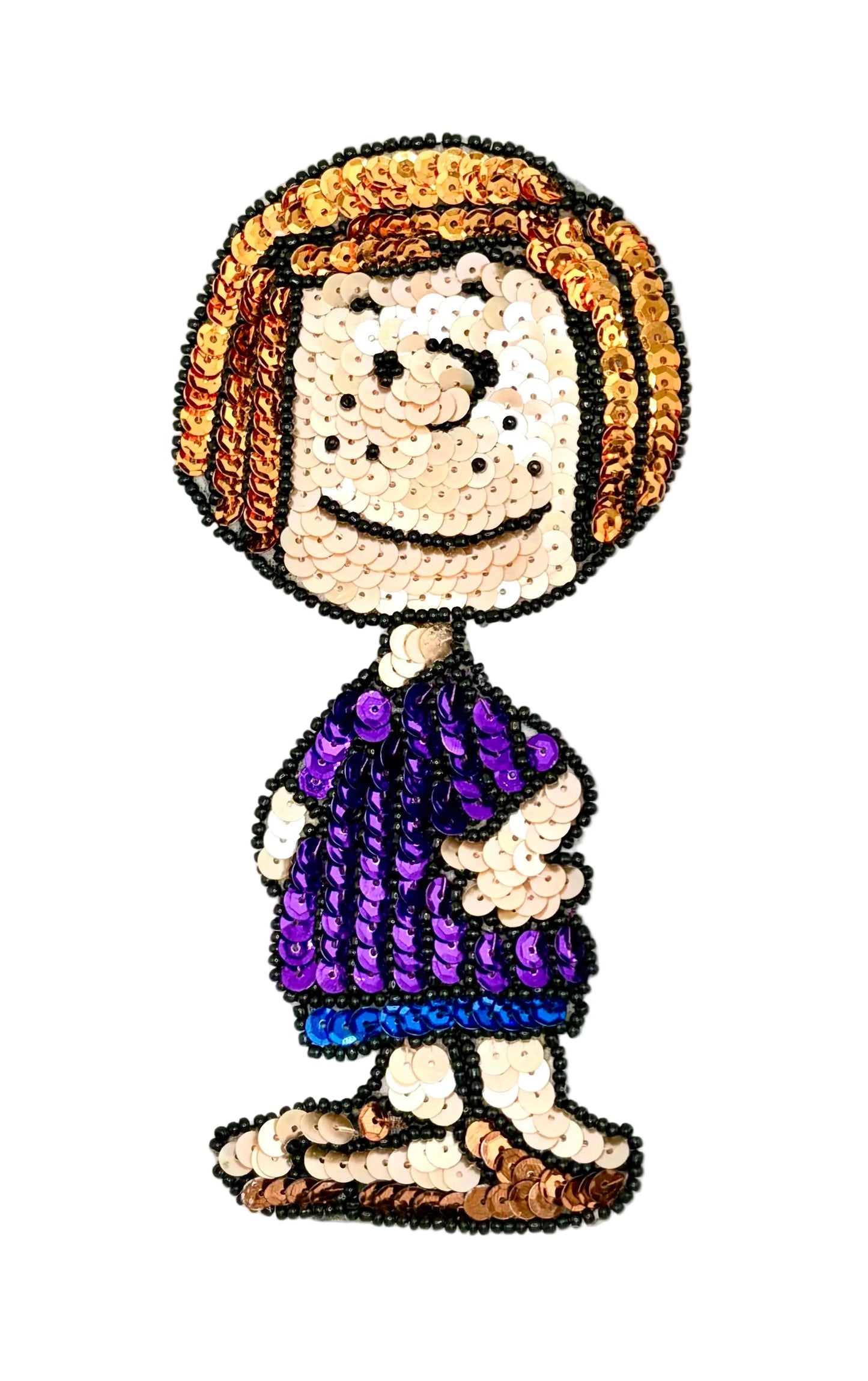 A stylized cartoon character patch or applique made from sequins, featuring short orange-brown hair, a beige face with freckles, a purple dress with blue trim, and brown shoes, shown on a white background.