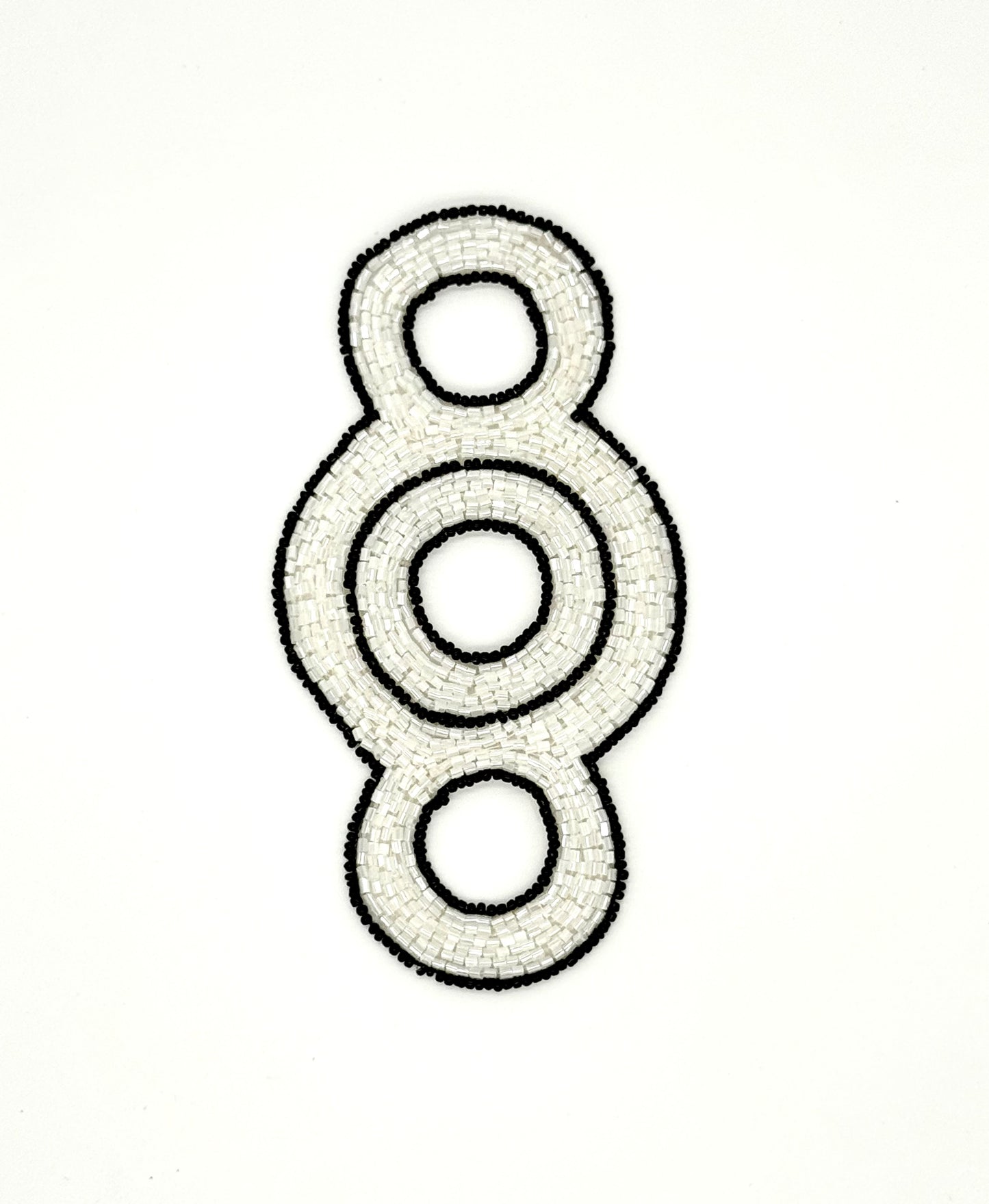 Decorative beaded accent with concentric circles on a white background