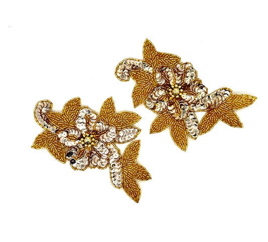 Pair of gold floral sequin and bead pair on a white background