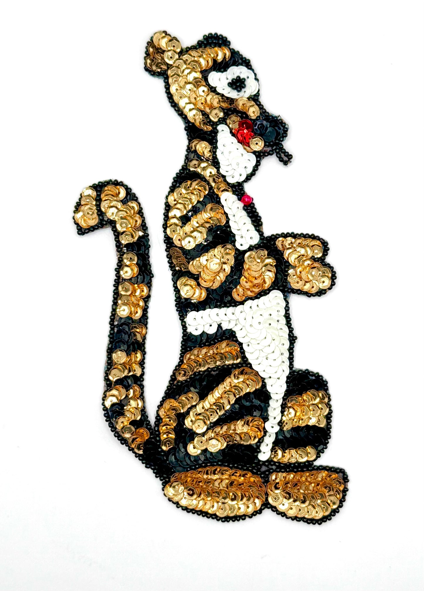 Sequined tiger character patch on a white background