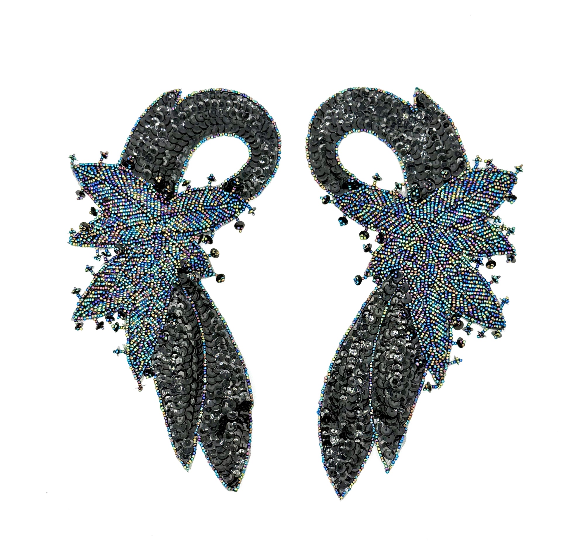 Pair of black beaded appliqués with beaded feather-like design on a white background