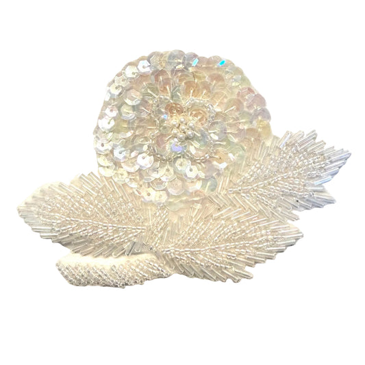 Add a shimmering floral accent to your next design with this iridescent sequin flower appliqué. Bugle, glass, and pearl beads bring varied texture and delicate detail to the flower.