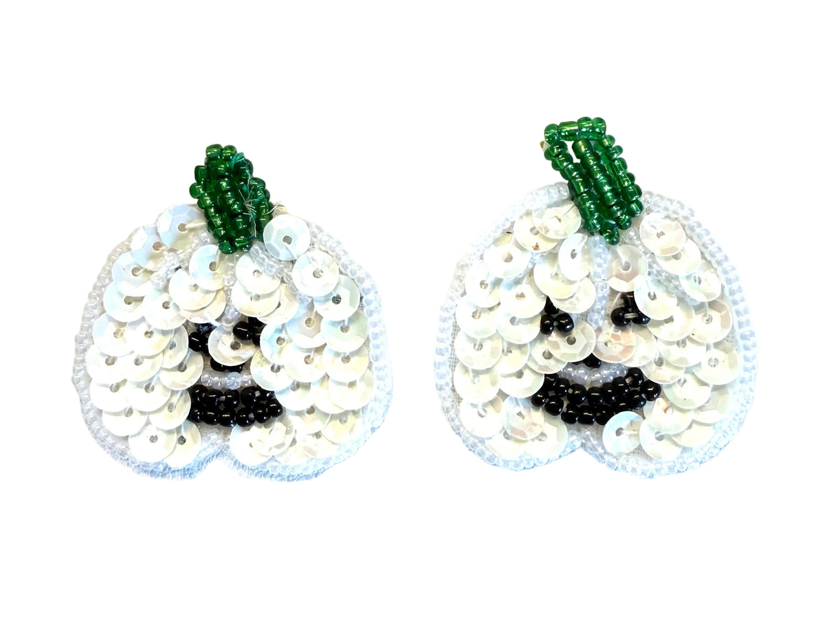 Two handmade sequin jack-o'-lantern patches with white sequins forming a pumpkin shape with a green beaded stem and a black beaded mouth on a white background.