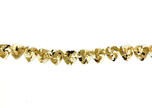 Gold sequin hearts by the yard on a white background
