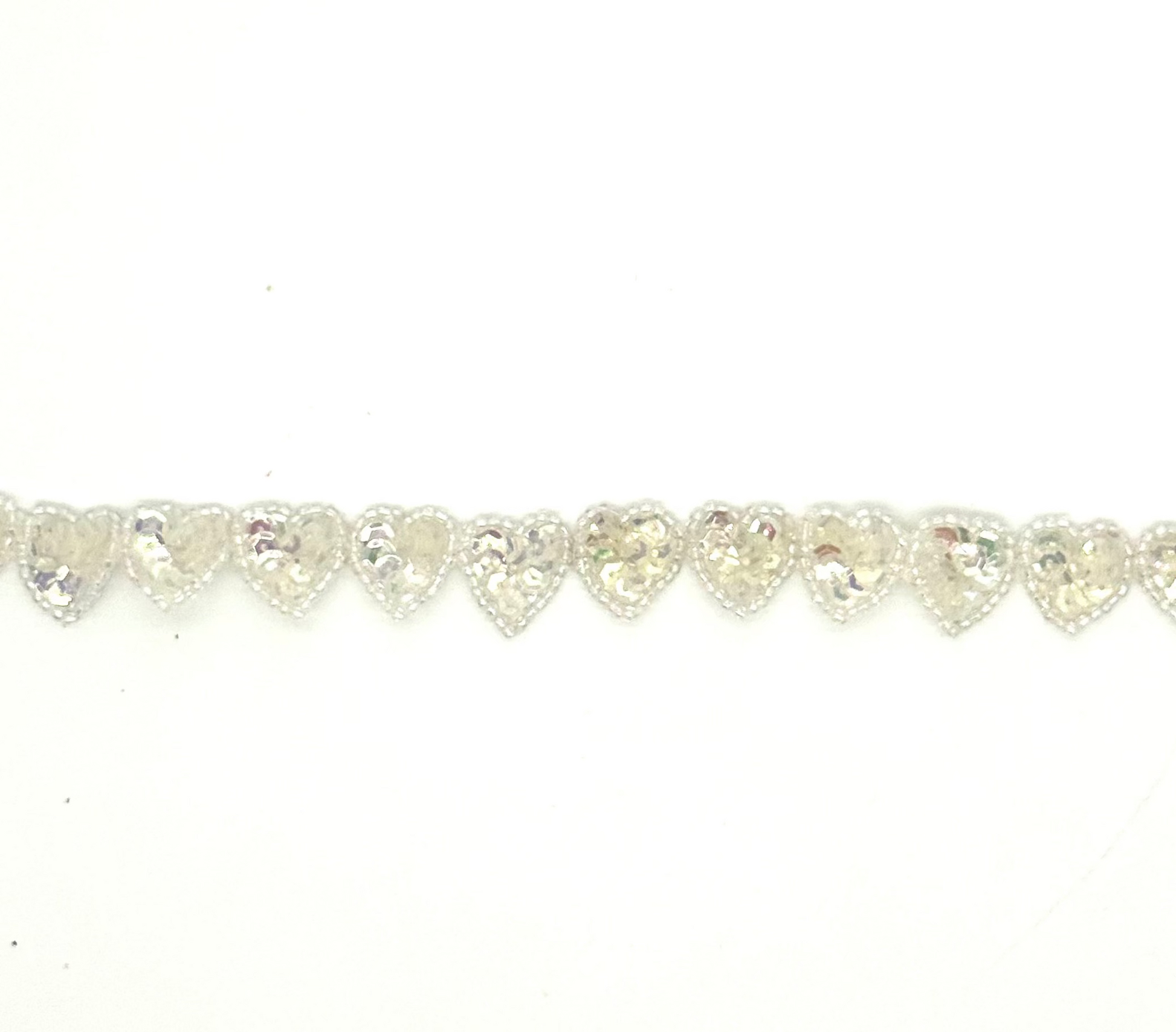 Heart-shaped sequin heart s by the yard on a white background