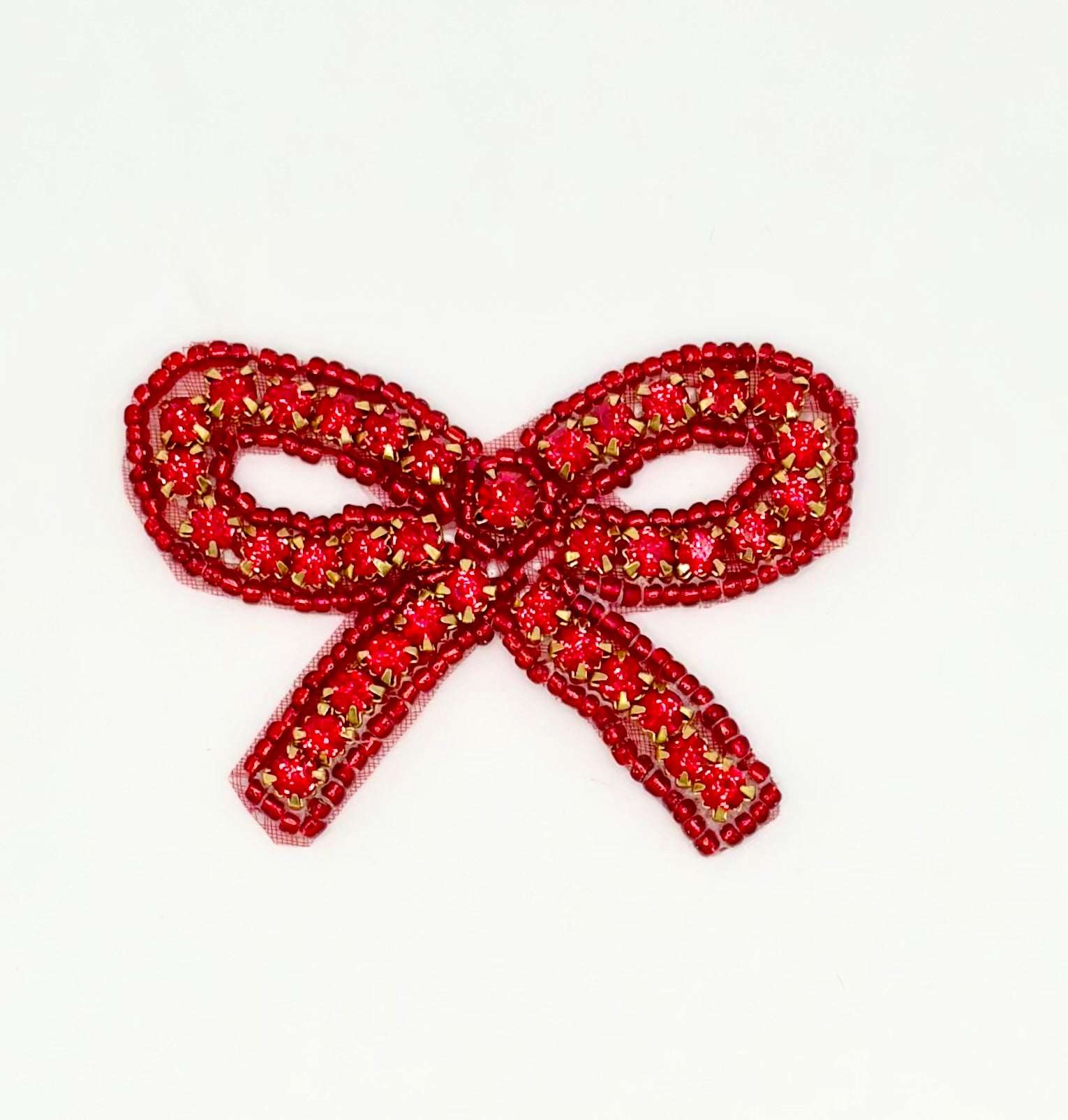 Red beaded bow on a white background