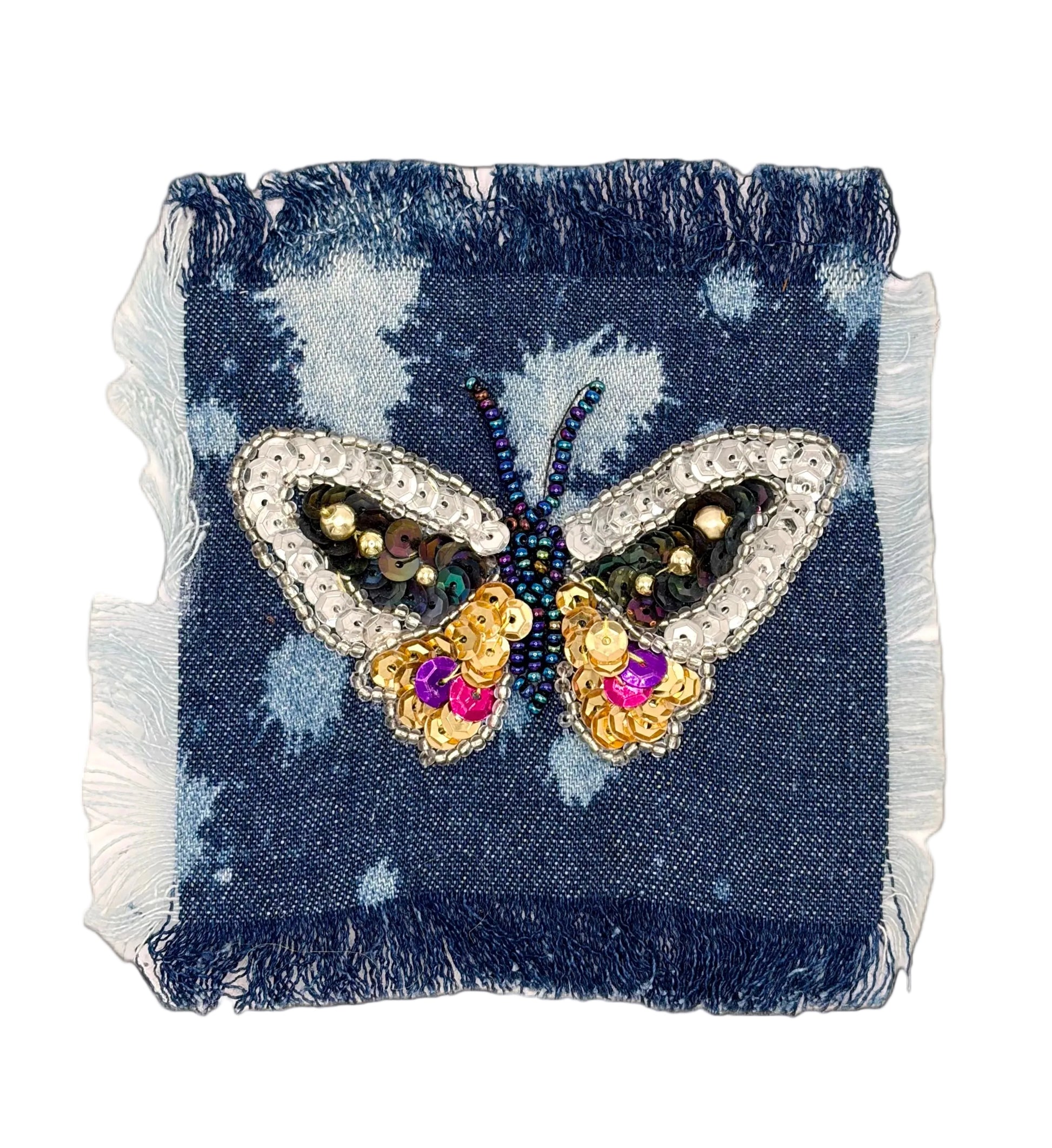 Butterfly-shaped sequin and bead appliqué on a denim patch with on a white background