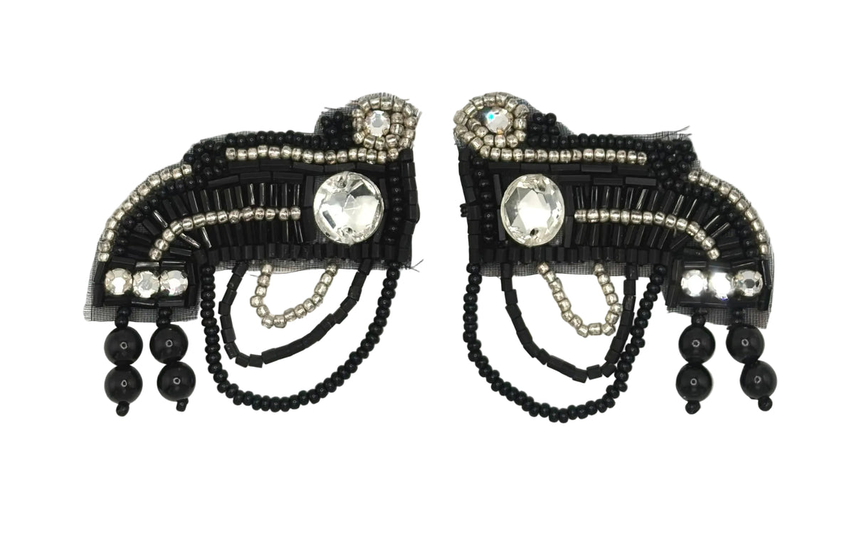 A pair of black beaded tconnectors for garments, clear rhinestones, and dangling black beads, displayed on a white background.