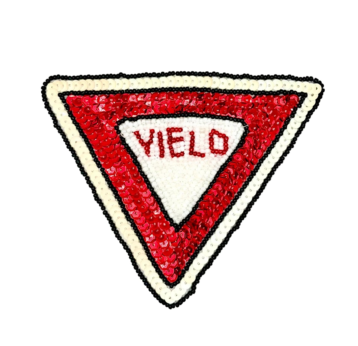 A triangular patch designed like a road sign, featuring a red sequined border, a white center, and the word 'YIELD' in red sequins, set against a plain white background.