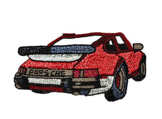 A vintage patch of a red sports car, styled like a classic Porsche 911, shown from the rear three-quarter view on a plain white background.