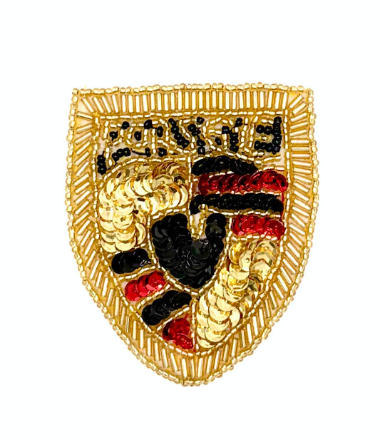 A gold shield-shaped sequin and bead vintage patch featuring the black, red, and gold Porsche crest design, isolated on a white background.