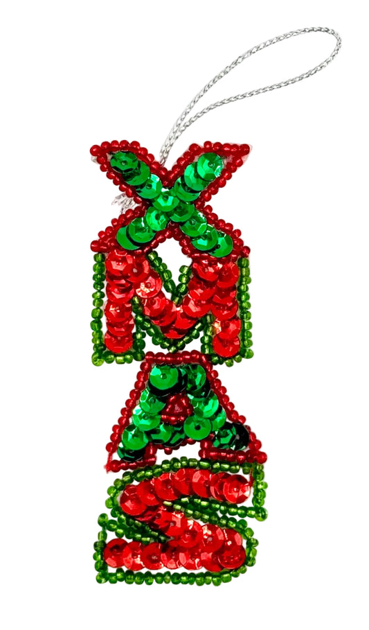 A Christmas ornament shaped like the letters 'XMAS' in a stacked, festive design, covered in red and green sequins with a silver hanging loop at the top, shown on a plain white background.