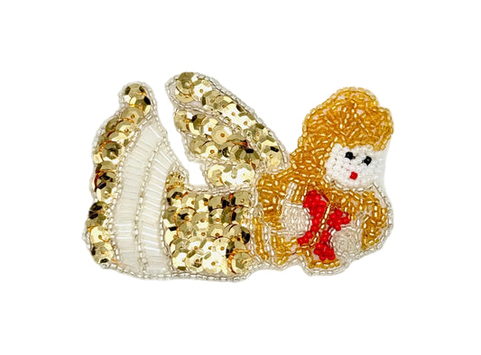 A decorative sequin  patch featuring a stylized angel figure with gold sequined wings, white beaded details, and a red bow, shown on a plain white background.