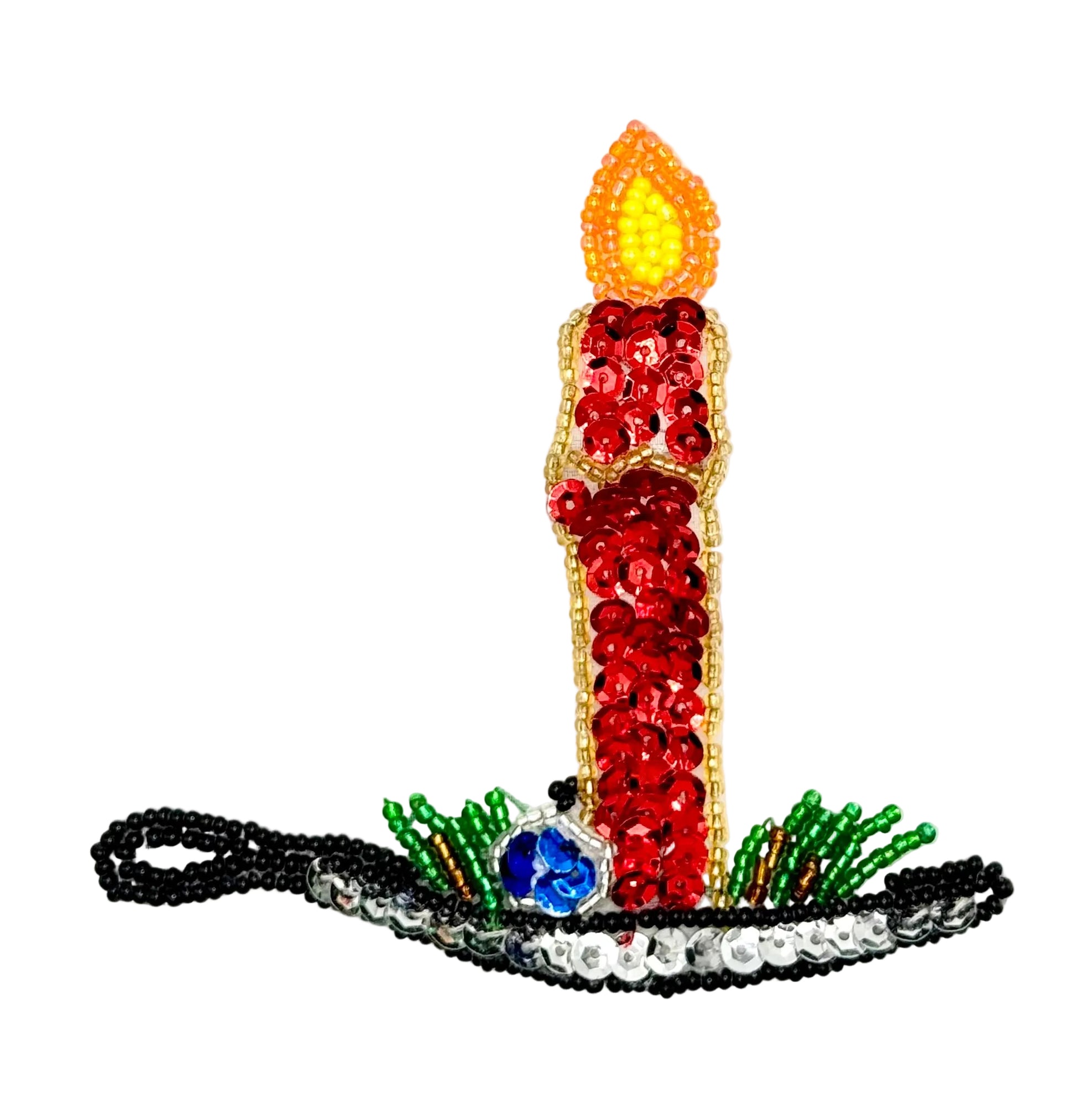 A decorative candle-shaped embellishment or patch with red sequins, a yellow and orange flame, green and silver beaded accents, and a blue sequin accent, shown on a plain white background.