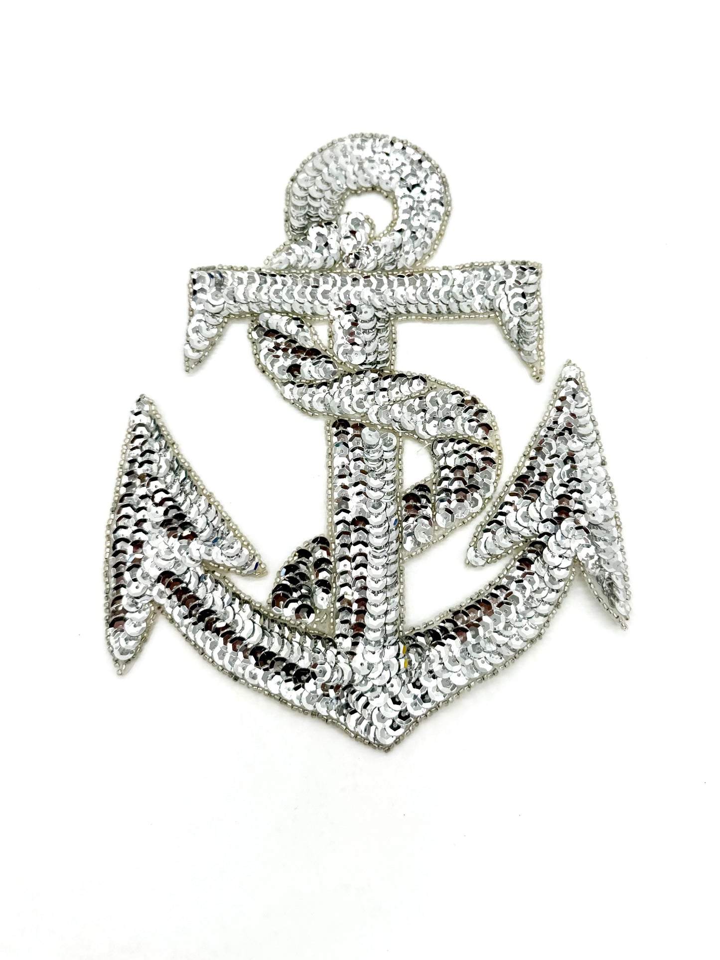 Silver anchor-shaped patch with sequins and beads item on a white background