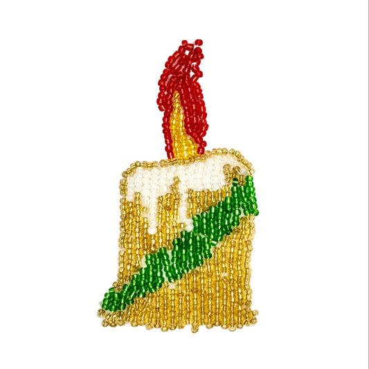 A beaded patch shaped like a Christmas  candle with a flame on top, made from glass beads, white beads for dripping wax, a green diagonal stripe, and a red and yellow  flame.