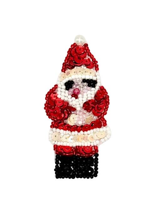 A beaded Christmas appliqué shaped like Santa Claus, featuring red sequins for the coat and hat, white beads for the face and trim, black beads for the pants and eyes, and a small pink nose, shown on a plain white background.