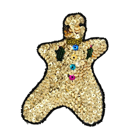 A gingerbread man-shaped sequin embellishment patch on a white background. The patch is covered in gold sequins with a black bead border, a gold collar, and colorful buttons in blue, yellow, orange, pink, and green.