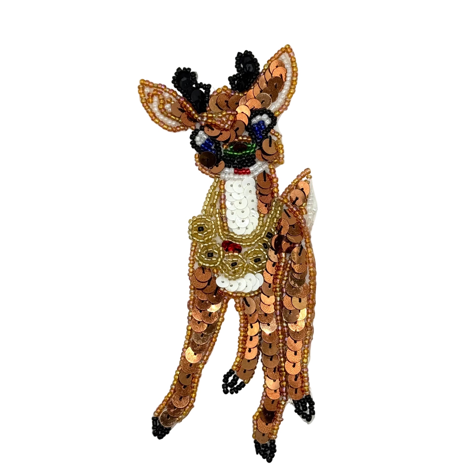 A decorative beaded and sequined reindeer appliqué or patch on a plain white background. The deer is primarily brown and gold with white, black, and small red and blue bead accents.
