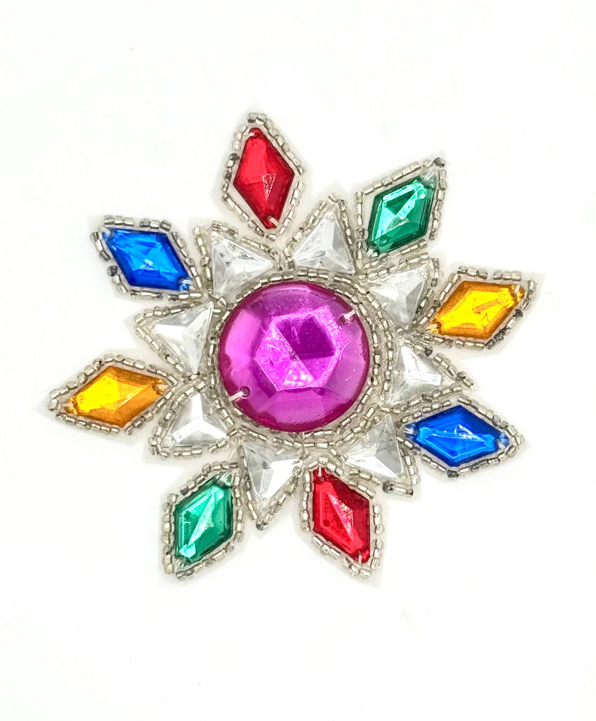 A colorful starburst patch featuring a central pink gemstone surrounded by red, blue, green, and yellow gemstones in a silver-tone setting, shown on a plain white background.