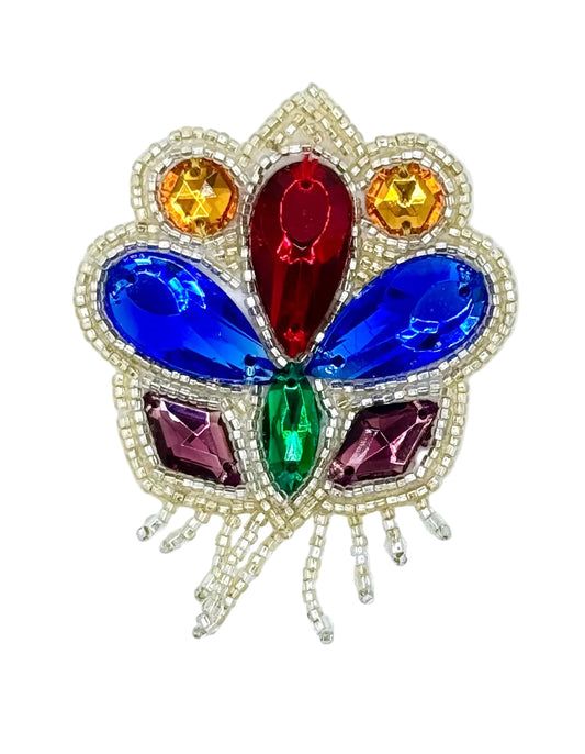 A colorful butterfly-shaped rhinestone patch with a silver beaded outline. The center features a large red teardrop crystal, flanked by blue teardrop crystals, with smaller green, purple, and gold crystals, and a silver beaded border.