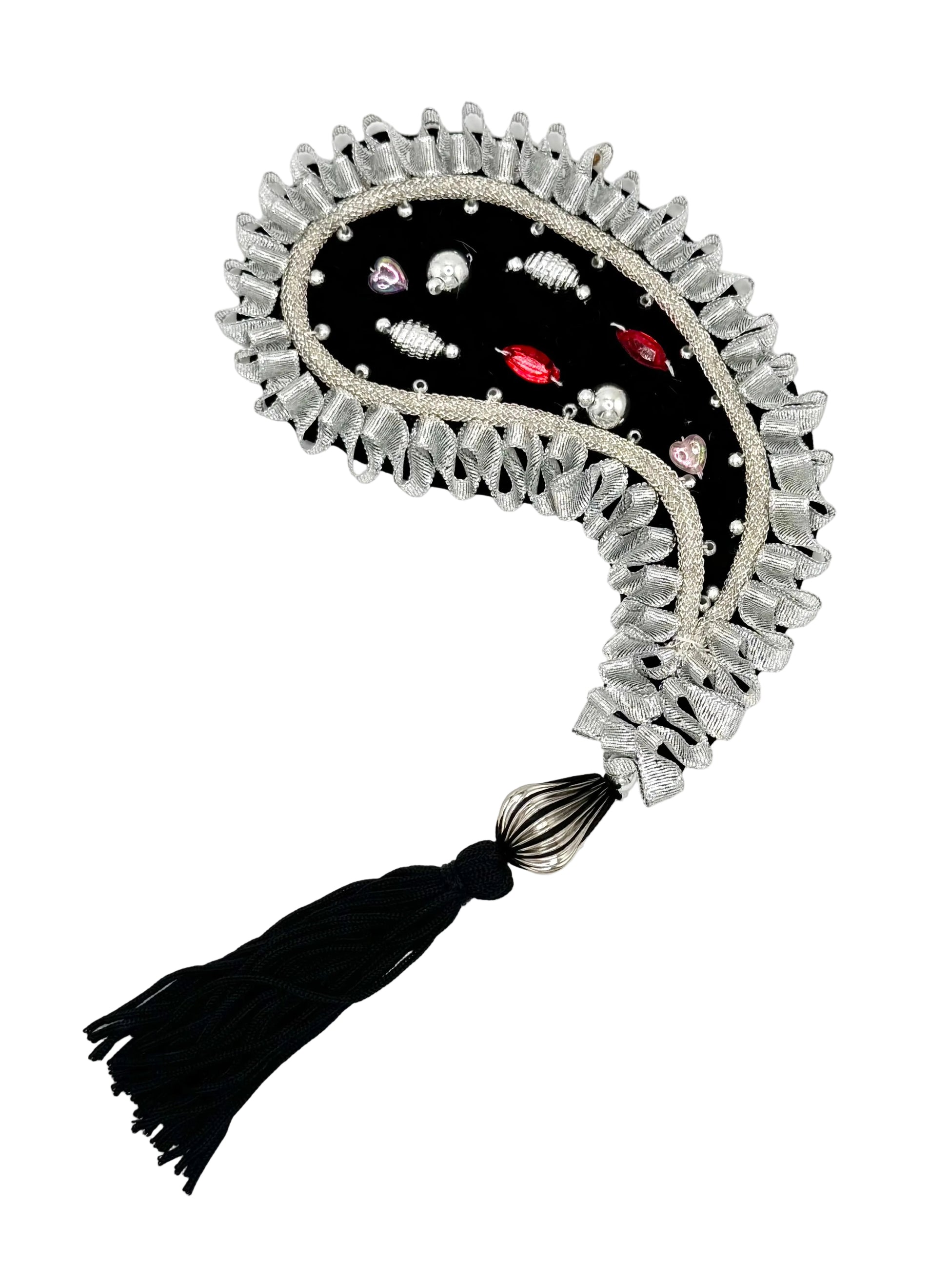 A decorative black and silver paisley appliqué  with small colorful bead accents, and a black tassel, shown on a plain white background.