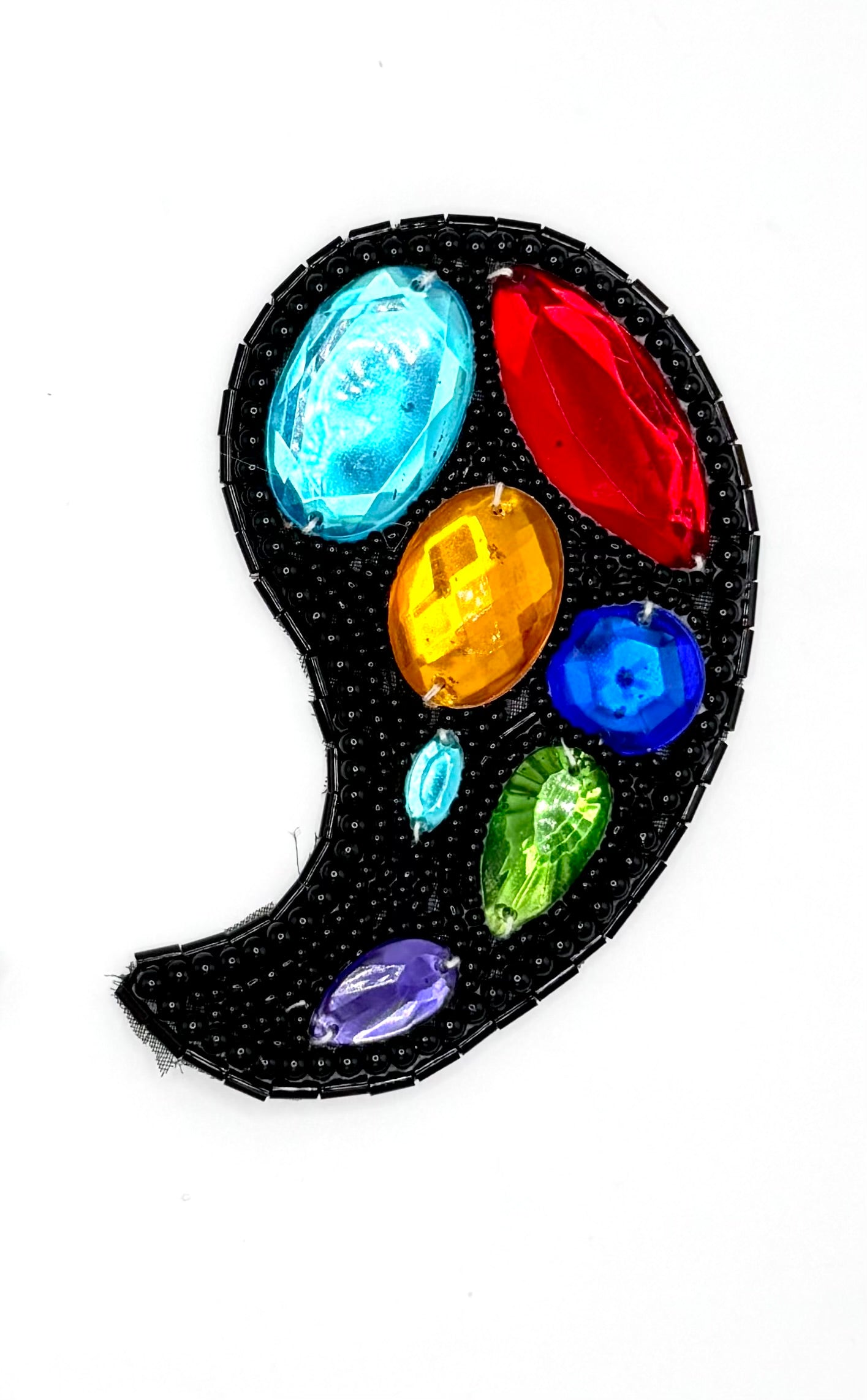 A black beaded paisley patch embellished with colorful faux gemstones in red, blue, yellow, green, purple, and light blue, shown on a plain white background.