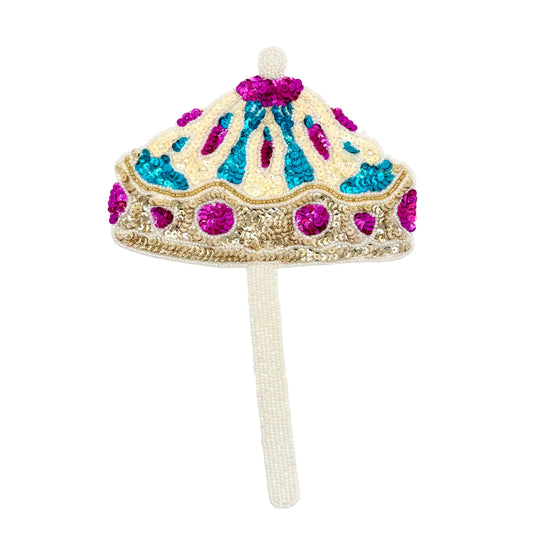 A sequin umbrella beaded with a long white beaded stem, featuring cream, turquoise, and magenta sequins on a white background.