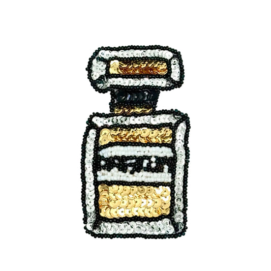 A sequined patch shaped like a perfume bottle, featuring gold, silver, black, and white sequins on a plain white background.