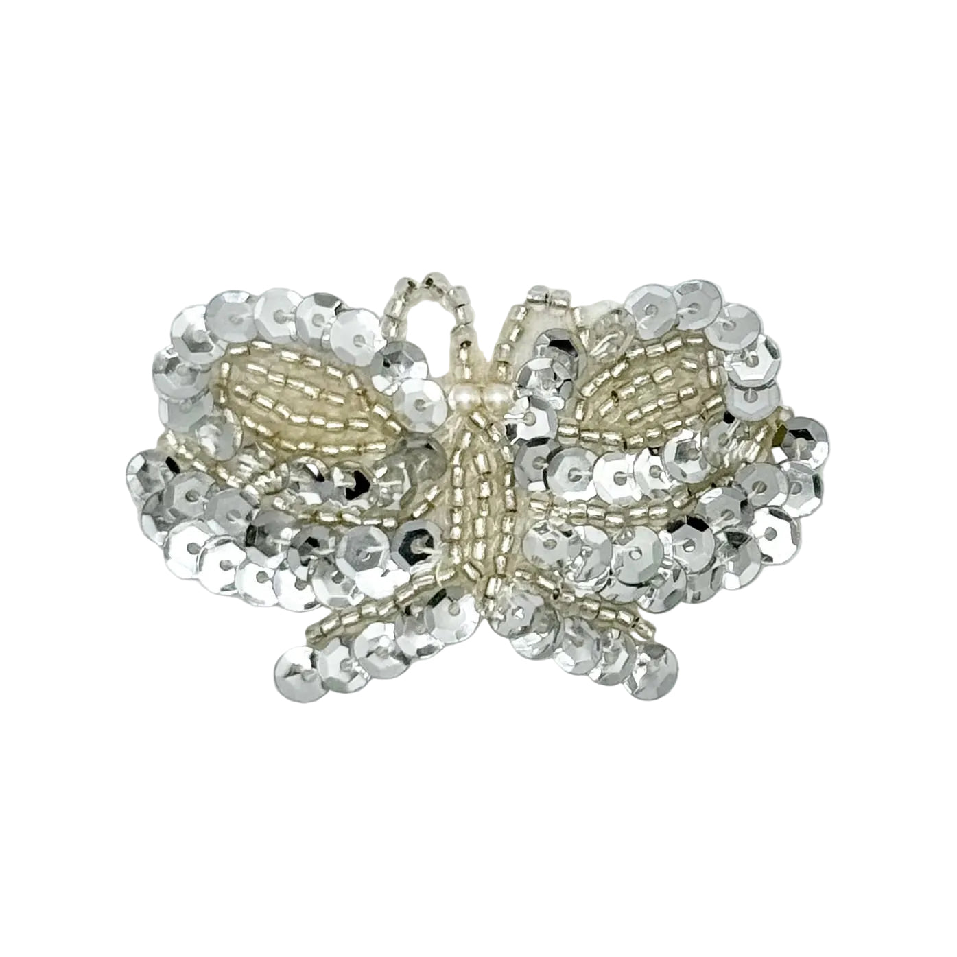 A butterfly-shaped embellishment or applique made from silver sequins and beige sglass beads, shown on a plain white background.