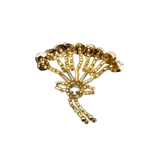 A gold-toned beaded fan-shaped patch with a central clear faceted gemstone, displayed on a clean white background.