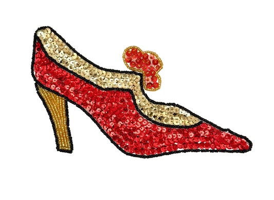 A red and gold sequined high-heeled shoe applique with a small red bow detail, shown on a plain white background.