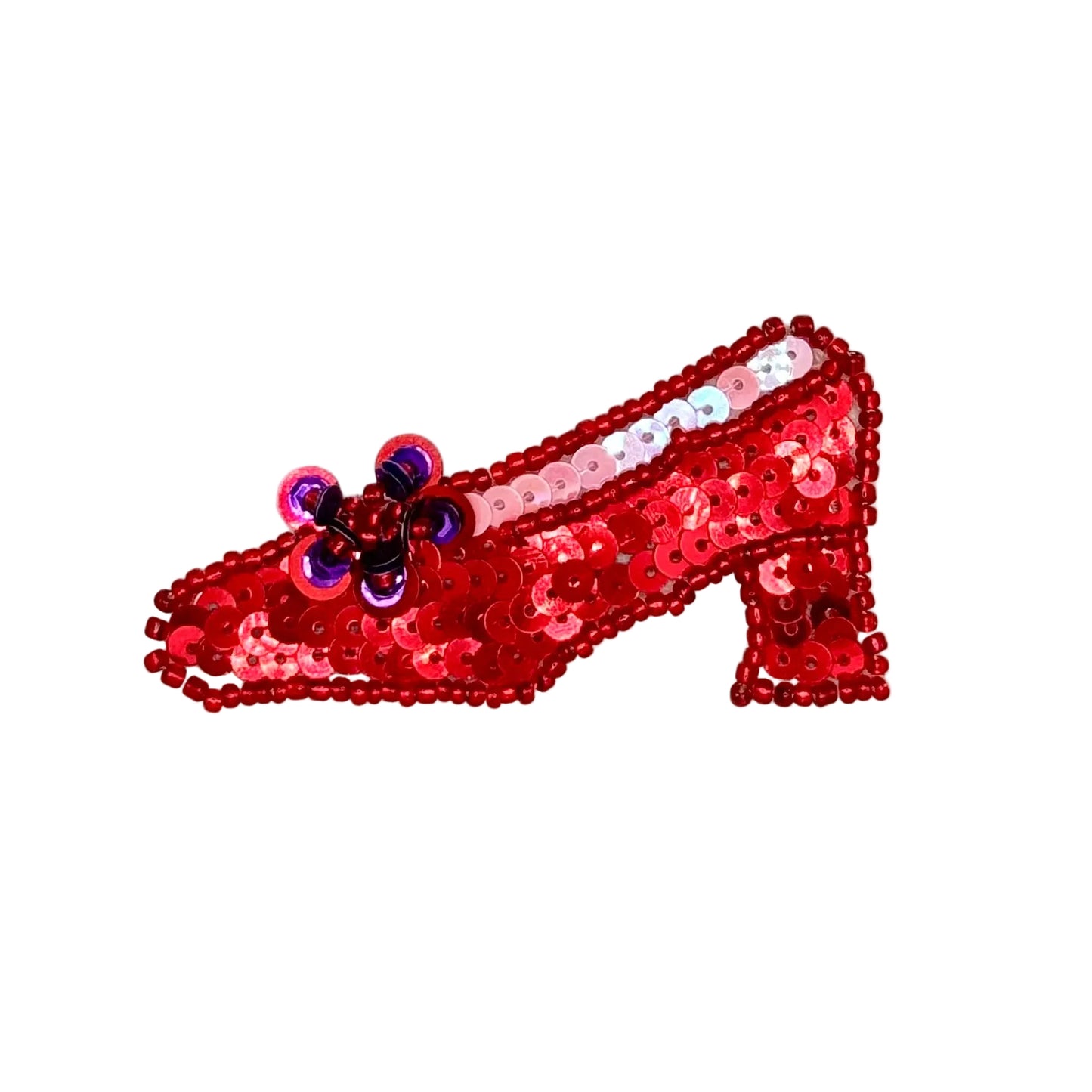 A red sequined high-heeled shoe patch with a small purple and blue bow detail, shown on a plain white background.