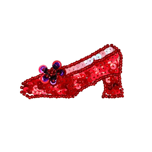 A red sequined high-heeled shoe patch with a small purple and blue bow detail, shown on a plain white background.