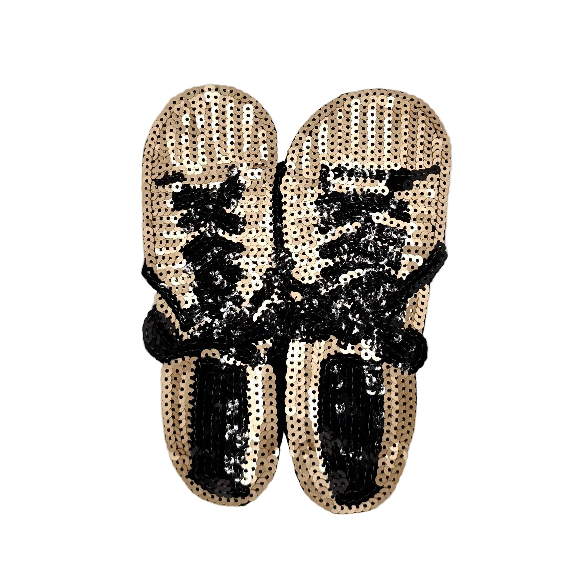 A pair of gold and black sequin sneakers on a white background.