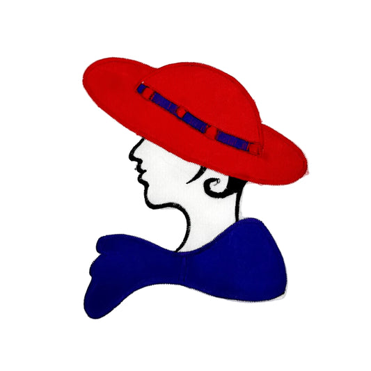 A stylized embroidered patch of a woman's profile wearing a red hat with a purple band and a purple bow, on a white background.