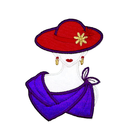 An embroidered patch of a stylized woman's bust wearing a red hat with a gold flower accent, red lips, gold earrings, and a purple draped scarf, shown on a plain white background.