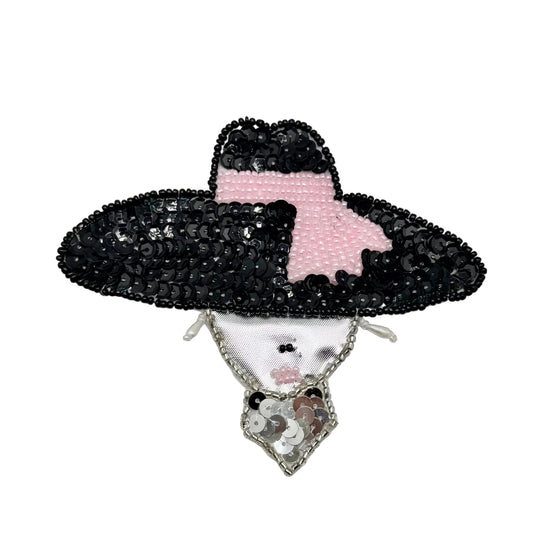 A beaded costume accessory featuring a black sequined hat with a pink beaded band, a silver satin face, and dangling earrings on a white background. 