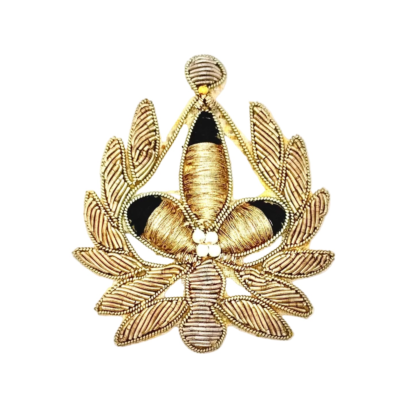 An ornate embroidered emblem or patch featuring a central gold and black floral motif surrounded by a leafy wreath, finished with small white pearl-like accents at the center, shown on a plain white background.