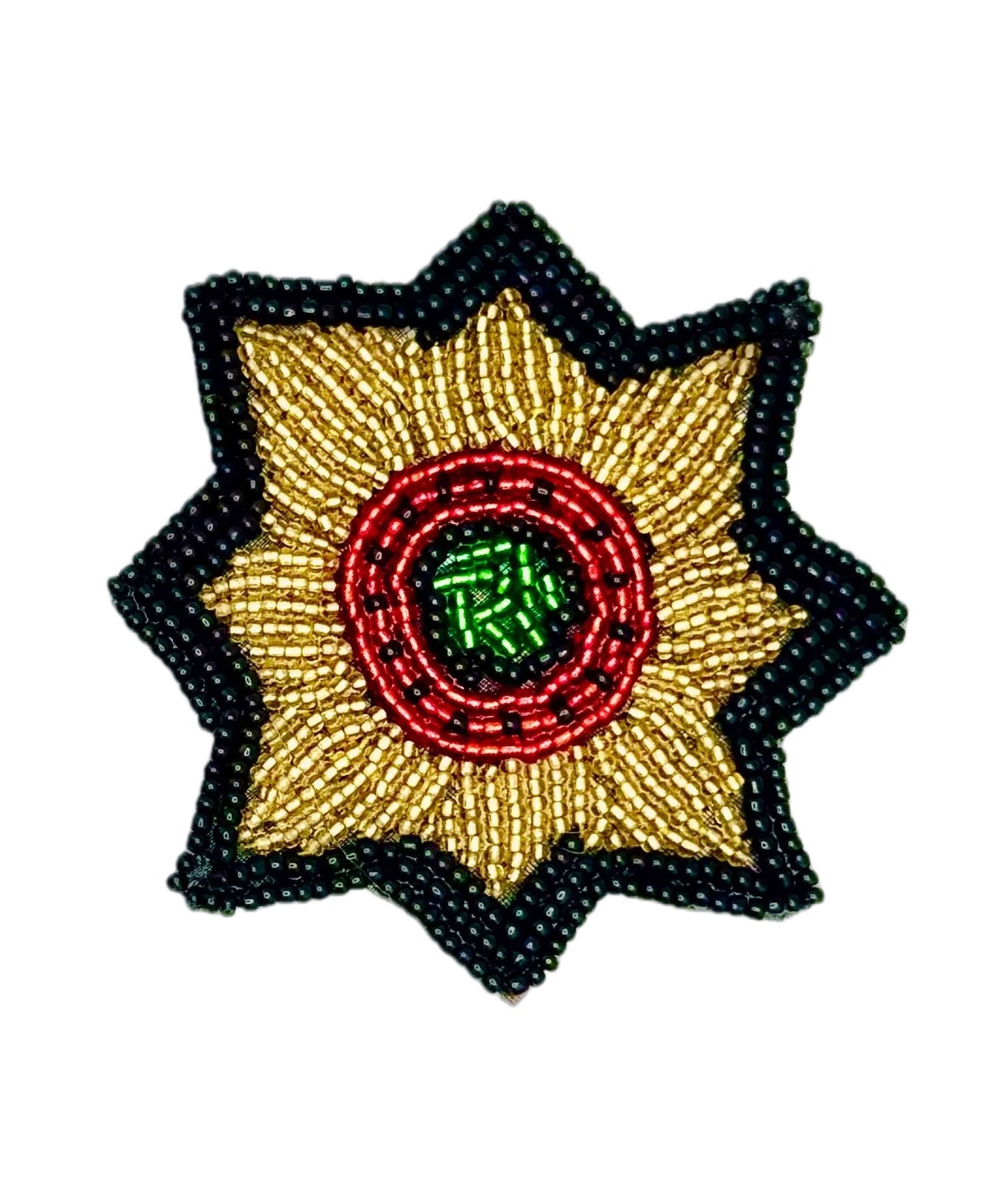 A star-shaped beaded patch with a gold center, a red circular band, a green inner circle, and a black outer border, shown on a plain white background.