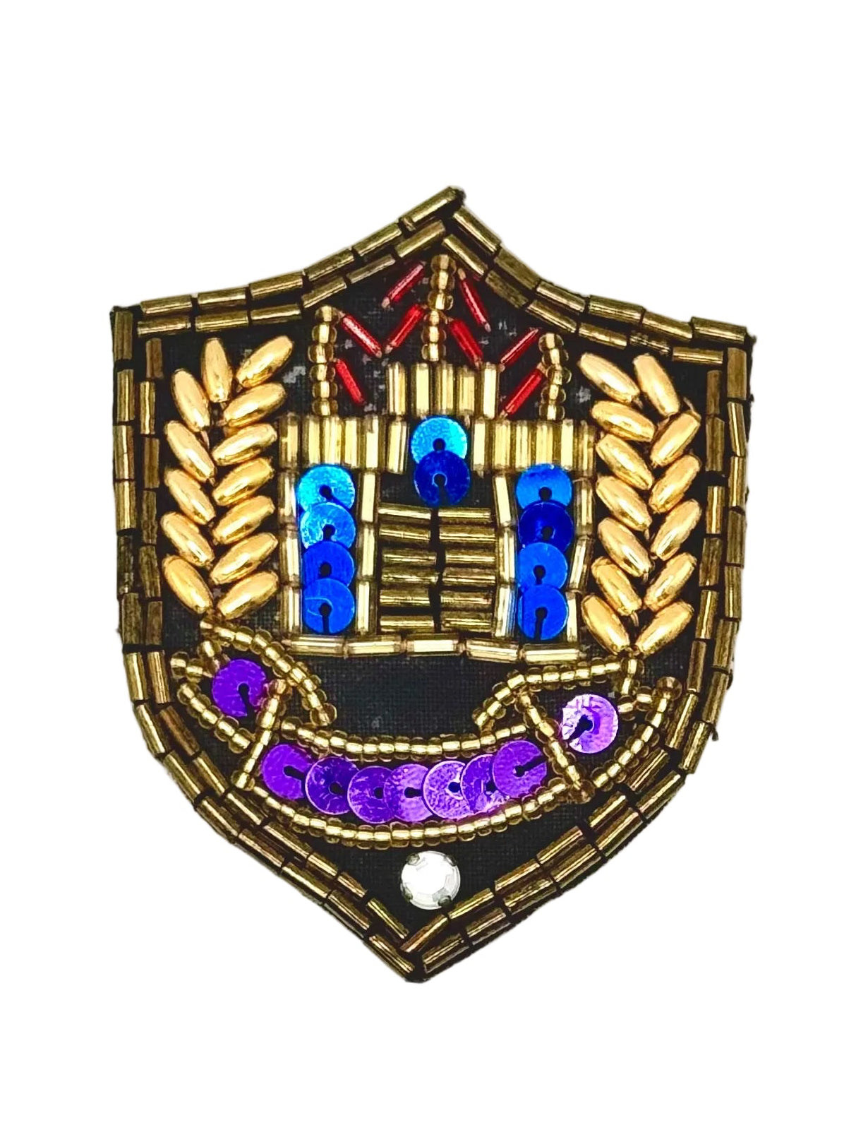 A shield-shaped beaded patch with a bronze metallic beaded border, featuring blue and purple sequins, red accents, and gold leaf-like beads on a white background.