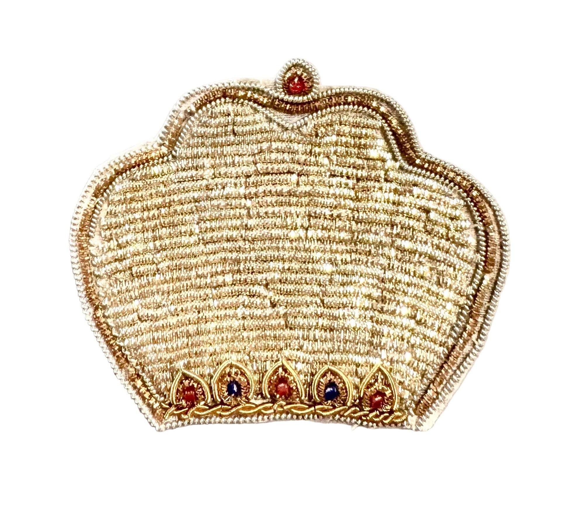 An embroidered patch shaped like a traditional Indian crown, featuring intricate gold and beige threadwork with small red and blue jewel accents, placed on a light-colored surface.