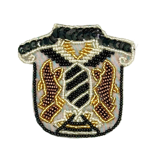 A shield-shaped beaded patch with a black beaded collar and a central crest featuring black, gold, and brown details on a white background.